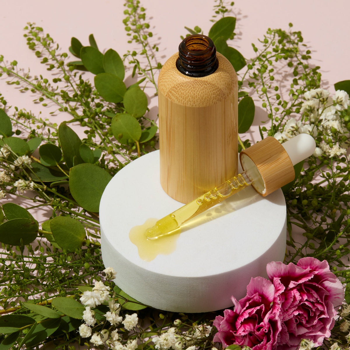 Cuticle oil in a bamboo bottle with dropper