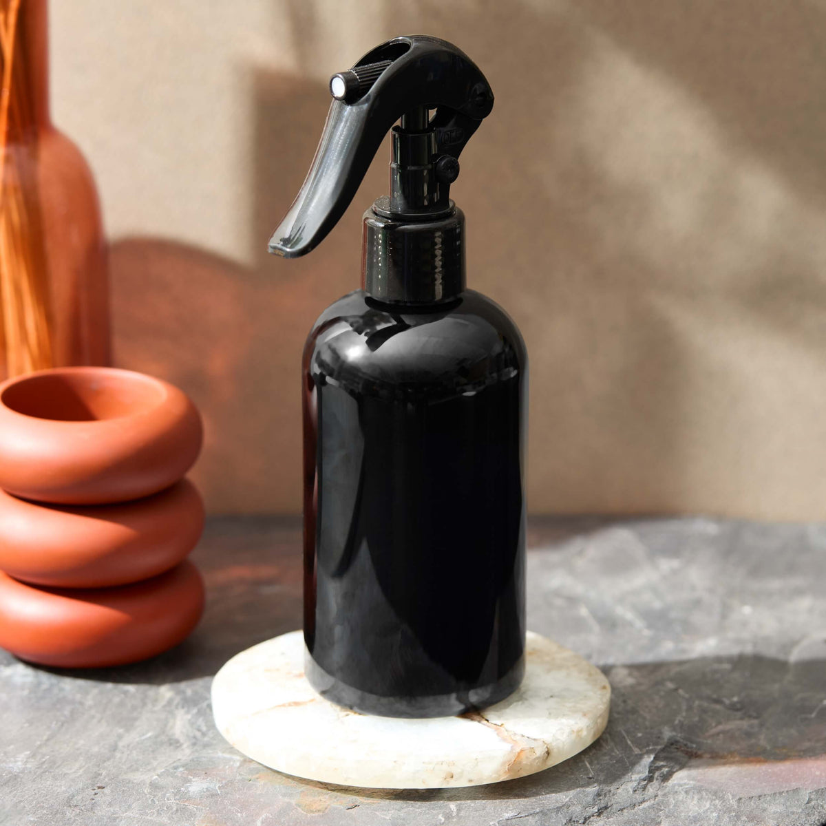 room spray in a black bottle with trigger sprayer