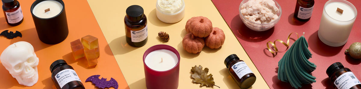 Seasonal candles, fragrance oils, soaps, and body scrubs arranged on orange, yellow, and red backgrounds with Halloween skulls and bats, autumn pumpkins and leaves, and a green Christmas tree candle.
